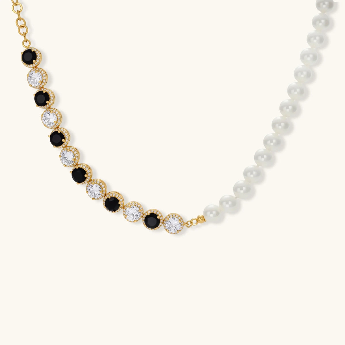 Gold-plated jewelry set with alternating black and clear cubic zirconia stones, featuring necklace, earrings and bracelet