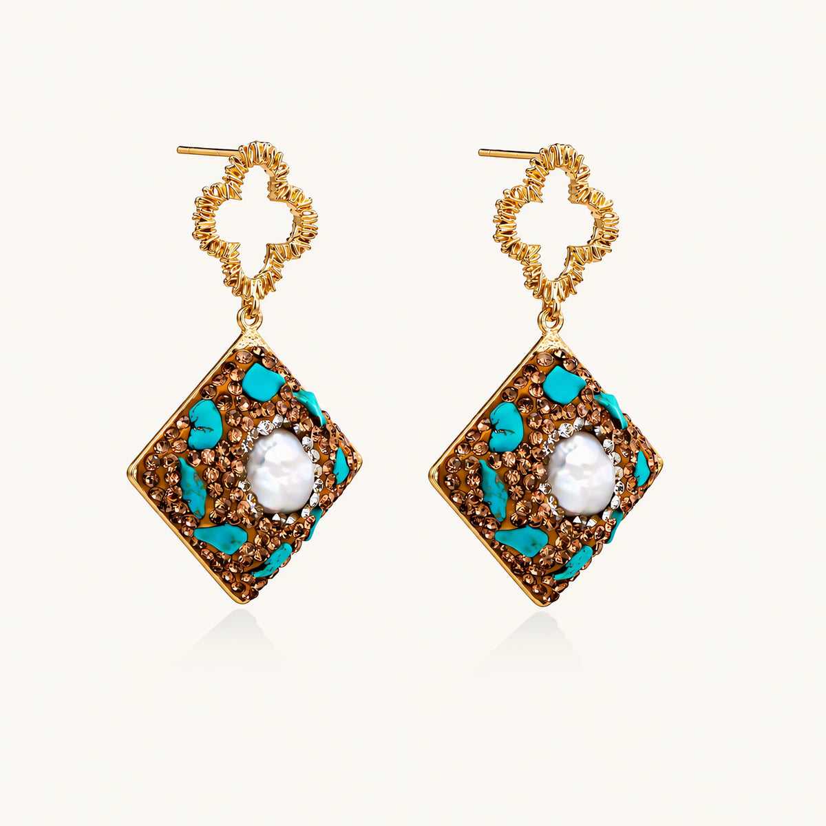 Gold-plated drop earrings with quatrefoil studs, diamond-shaped pendants featuring baroque pearls, turquoise stones, and amber crystals