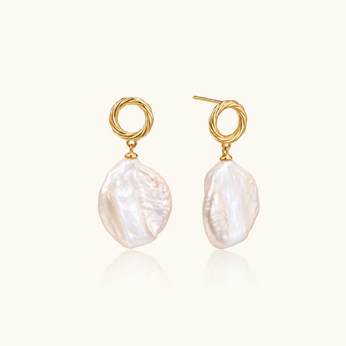18K gold vermeil twisted circle studs with organic white baroque pearl drops on cream background