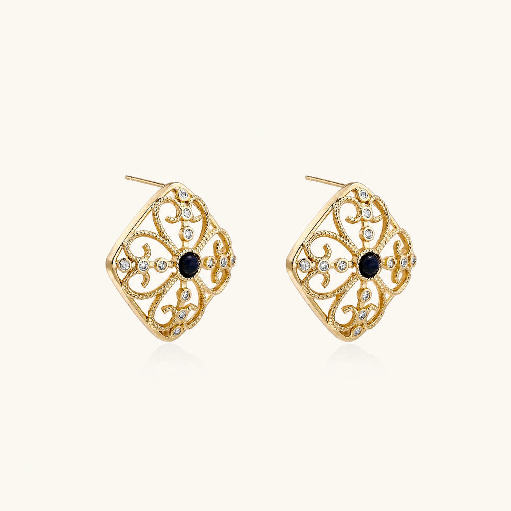 Gold filigree stud earrings with navy lapis lazuli center stone and mother-of-pearl accents in ornate quatrefoil design