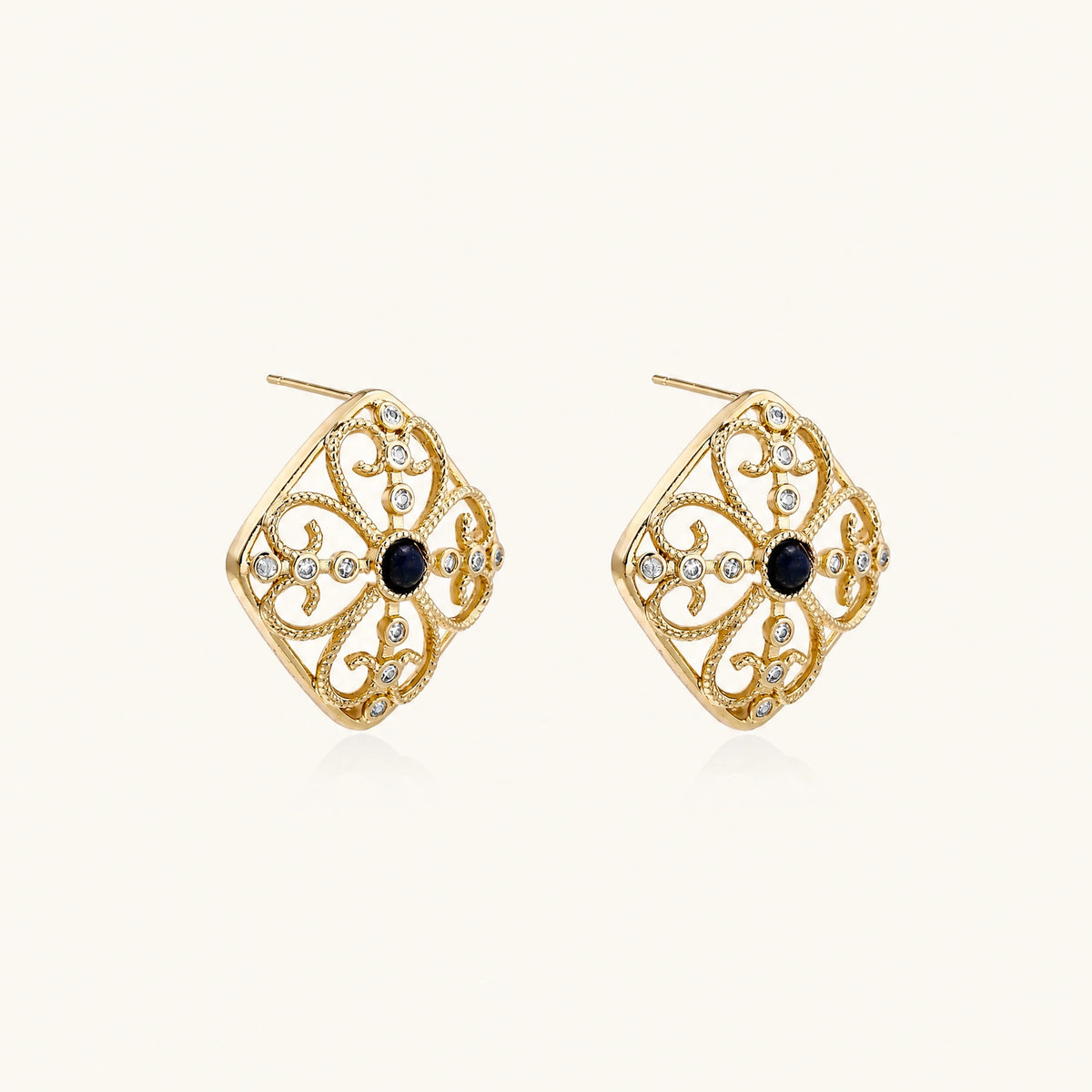 Gold filigree stud earrings with navy lapis lazuli center stone and mother-of-pearl accents in ornate quatrefoil design