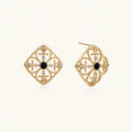Gold filigree stud earrings with navy lapis lazuli center stone and mother-of-pearl accents in ornate quatrefoil design