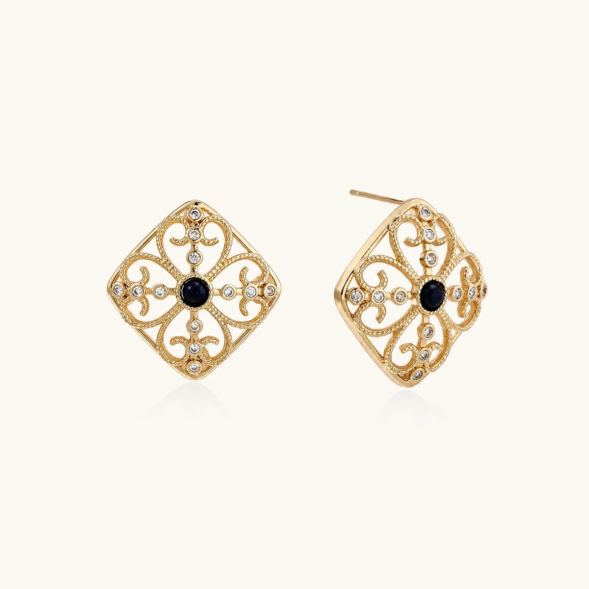 Gold filigree stud earrings with navy lapis lazuli center stone and mother-of-pearl accents in ornate quatrefoil design