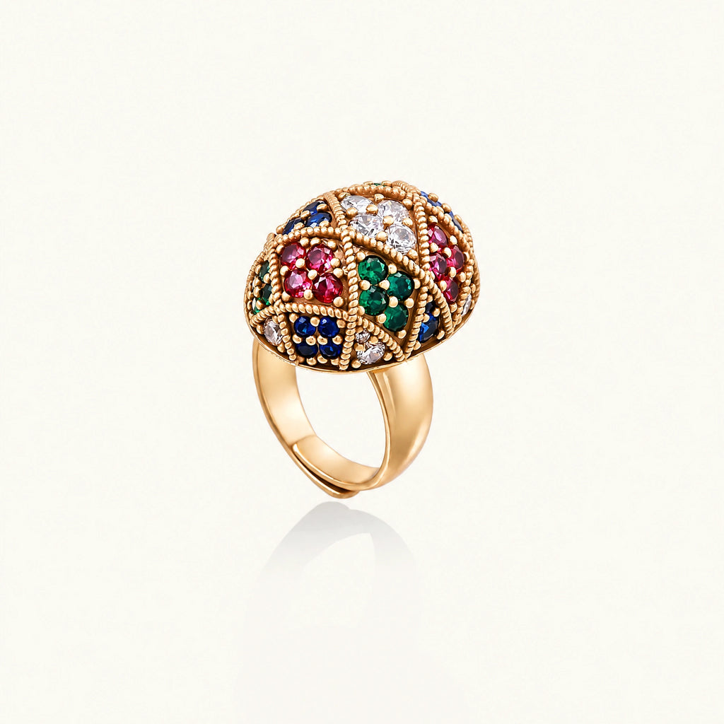 Oversized gold ring with geometric mosaic pattern featuring multicolor zirconia stones in ruby, emerald, sapphire, and clear tones.
