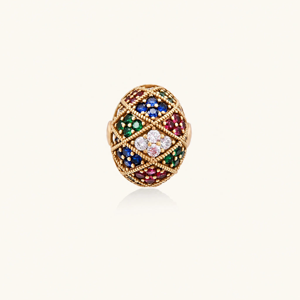 Oversized gold ring with geometric mosaic pattern featuring multicolor zirconia stones in ruby, emerald, sapphire, and clear tones.
