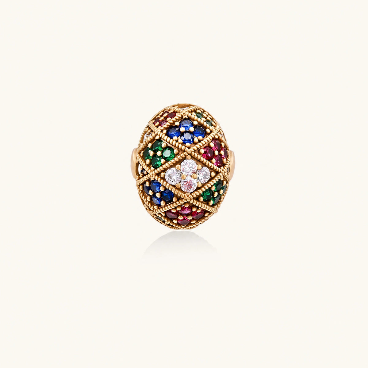 Oversized gold ring with geometric mosaic pattern featuring multicolor zirconia stones in ruby, emerald, sapphire, and clear tones.