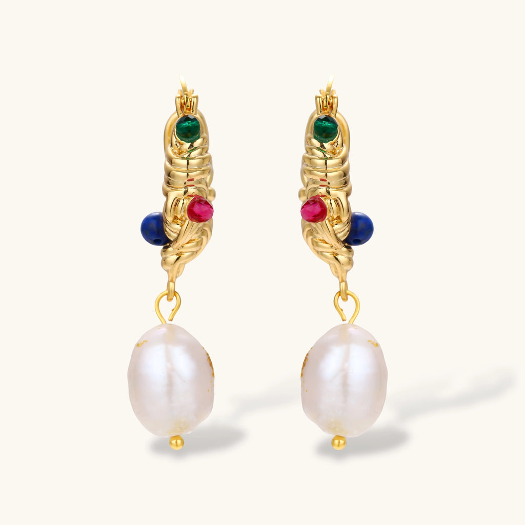 Pair of gold twisted-rope hoop earrings with green, pink and blue beads and baroque freshwater pearl drops on a cream background.