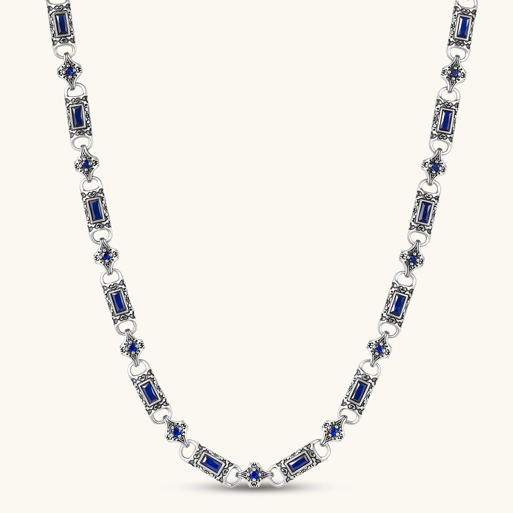 Antique silver plated eco-brass link necklace with blue baguette and round cubic zirconia in ornate scrollwork settings.