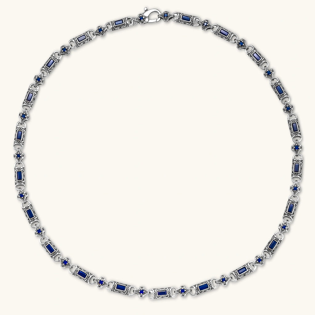 Antique silver plated eco-brass link necklace with blue baguette and round cubic zirconia in ornate scrollwork settings.