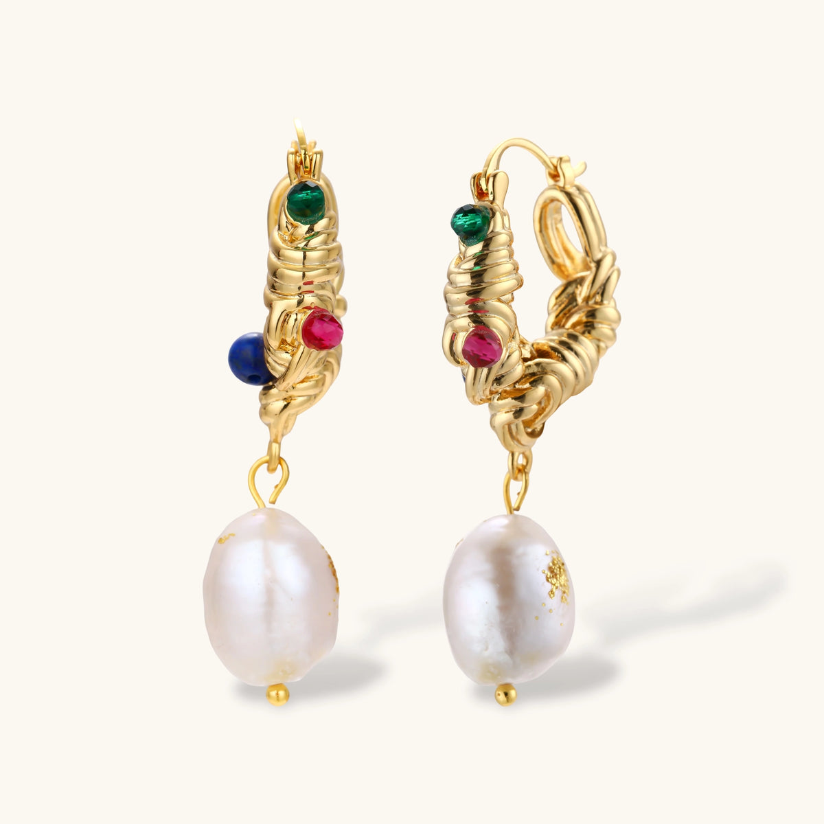 Pair of gold twisted-rope hoop earrings with green, pink and blue beads and baroque freshwater pearl drops on a cream background.